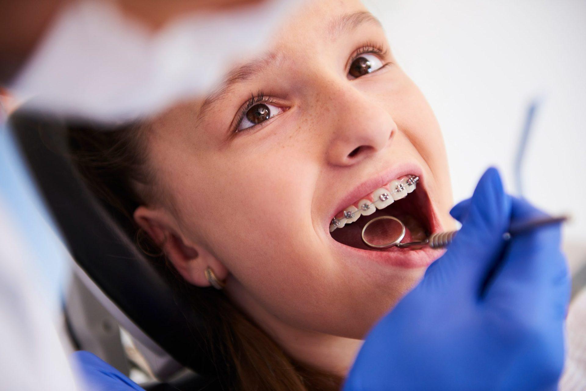 girl with braces during a routine dental examination