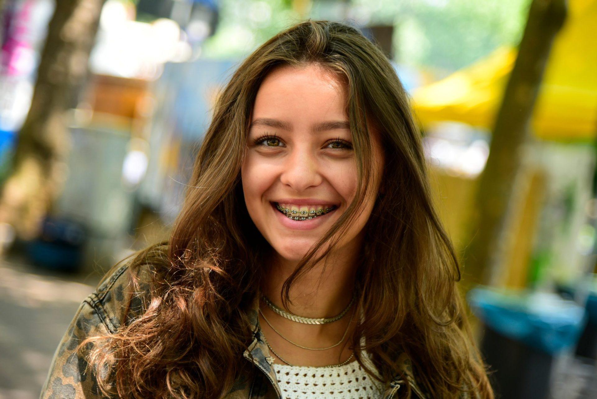portrait of laughing teenage girl wearing braces