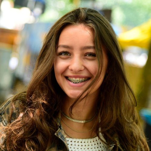 portrait of laughing teenage girl wearing braces