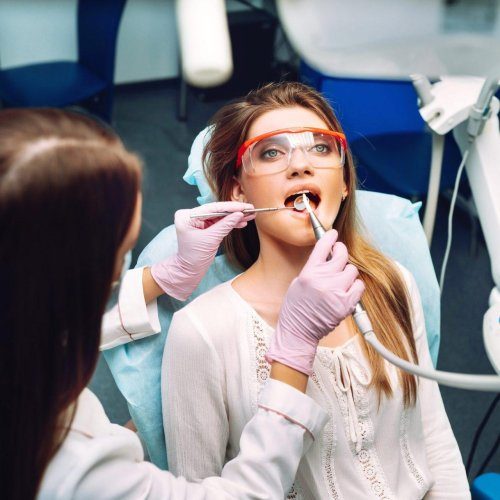 young woman at the dentist s chair during a dental procedure overview of dental caries prevention r8e7hftp22bzhci2jvri6q7abbmykjpa9b6hqcngqw
